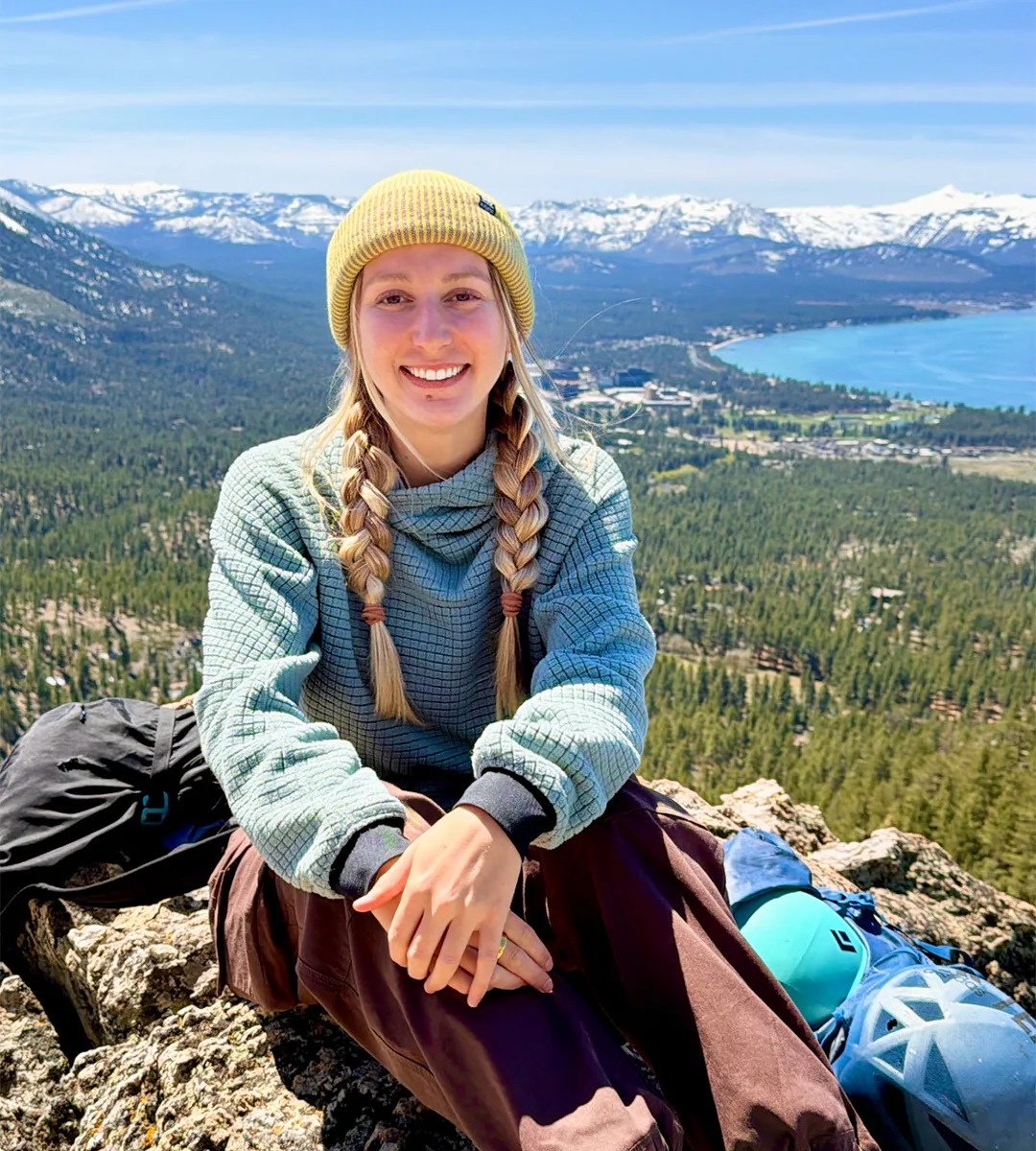 Emersyn sitting on a granite summit above South Lake Tahoe